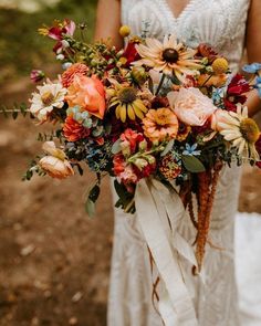 a woman holding a bouquet of flowers in her hands