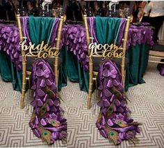 two chairs with purple and green sashes on them, decorated with peacock tail feathers