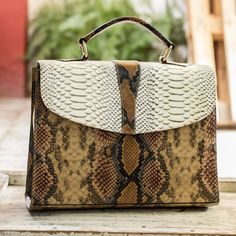 This stylish handbag is the original design of Adelina Saldana in Nicaragua. The bag is crafted from top-quality leather that has been printed with an assortment of snakeskin motifs. The fully lined interior includes a convenient zipper pocket. Handbag Handles, Streetwear Tshirt, Shirt Ideas, Printed Leather, Nicaragua, Snake Print, Leather Handbag, Handbag Accessories, Louis Vuitton Damier