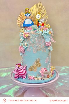 there is a cake decorated with princesses and other things on the top of it