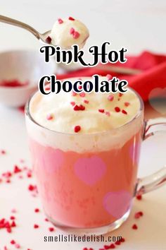 pink hot chocolate in a mug with sprinkles