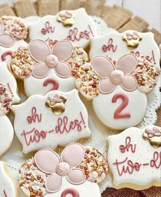 decorated cookies with numbers and bows are on a plate