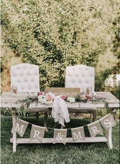 a table with chairs and a sign that says mr and mrs