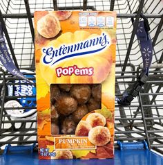 a box of popcorn sitting on top of a blue table next to a shopping cart