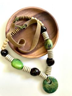 "Handmade chunky necklace that makes a great statement piece.  Big beautiful beads you'll love!  *Kukui Nuts from Hawaii, Tagua Nuts, Wooden Heishi Beads and Disc, Stone Pendant * Leather Cord and Suede Leather * Length: 18\" with pendant" Kukuiula Necklace Bead, Tagua Necklace, Heishi Necklace, Kukui Nut, Beaded Necklace Designs, Poly Clay, Tagua Nuts, Beaded Statement Necklace, Heishi Beads