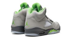 The Air Jordan 5 GS “Green Bean” is the youth sizing of the colorway of the retro basketball shoe with a reflective finish that was first released in 2006.  This May 2022 version of the Jordan 5 GS “Green Bean” is nearly identical to the original version of the sneaker from ‘06.  The shoe’s grey synthetic upper is treated with a reflective finish that is supposedly inspired by the original sketch of the Jordan 5 by Tinker Hatfield.  According to Nike, Hatfield originally designed the Air Jordan Jordan Dunk Low, Jordan 5 Retro Green Bean, 2022 Shoes, All Jordans, Sneakers Box, Kobe Shoes, Nike Air Jordan 5, Jordan 5 Retro, Ugg Classic Mini