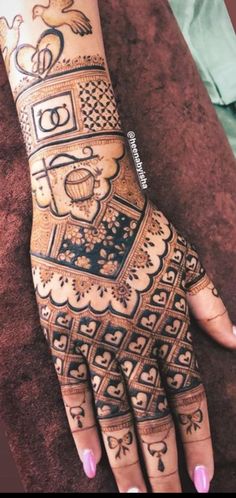 a woman's hand is decorated with hennap and designs on her hands