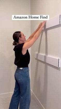 a woman standing in front of a white wall with the words amazon home find on it