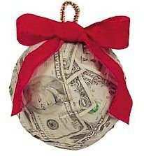 a money ornament with a red ribbon tied around it