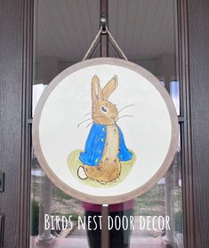 "Hand Painted watercolor Peter Rabbit whimsical Spring Door Hanger. *20\" Diameter *100% Hand Made in USA  *Quality Baltic Birch Plywood *Rope hanger comes attached.  *Sealed on BOTH sides with a non-yellowing, and UV resistant quality sealer. Front side gets two coats for added protection! *Back is finished with early American stain, for a polished look! *All details are hand painted (no vinyl) *Great Housewarming, Mothers Day, Birthday, or Realtor Gift.  SHOP POLICIES AND INFO *Shipping Inform Peter Rabbit Door Hanger, Rabbit Door Hanger, Hand Painted Door, Spring Door Hanger, Valentines Door Hanger, Painted Door, Pumpkin Garland, Spring Door, Realtor Gifts