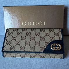 Authentic Gucci New Britt Monogram Canvas Trifold Wallet Interlocking Gg Gold Tone Hardware Leather Lining With One Interior Pocket And Three Dual Pockets And With Cards Slots, Snap Closes. Used Has Minor Wear Signs, Loose Thread Showing In Middle Between The Cards Slots, As Shown In The Pictures, Interior Pocket Has Wear Signs But Clean. Fainted Marks In The Interior At Opening, Overall In Good Used Condition. Comes With Box. Classic Gucci Wallet For Travel, Classic Gucci Travel Wallet, Designer Brown Wallet, Formal Brown Gucci Wallet, Gucci Brown Formal Wallet, Gucci Chic Wallet On Chain With Gold-tone Hardware, Luxury Brown Gucci Wallet, Gucci Designer Wallet On Chain With Gold-tone Hardware, Gucci Wallet On Chain With Gold-tone Hardware