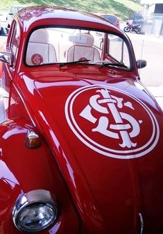 an old red car with a white emblem on it