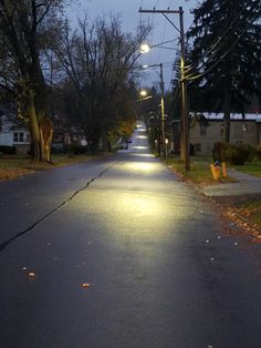 an empty street at night with the lights on