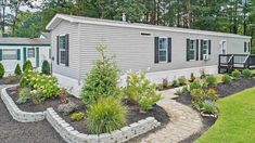 a mobile home with landscaping around it