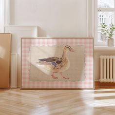 a duck standing in front of a window on a wooden floor