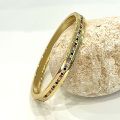 Flawless CZ encrusted hard bangle is a really special piece. Embrace your beauty and highlight your pretty appearance by wearing it, featuring an exquisite design. It is definitely a unique find! It is a hinged bracelet featuring 1 row of multi colored CZ stones adorning the center of the band on one side. This is a seriously pretty bangle that packs a sparkly punch! such an effortless and easy way to dress up any outfit, it makes a beautiful gift or a special treat for yourself.- Stones Materia Elegant Multicolor Stone Bangle, Multicolor Cubic Zirconia Bangle Jewelry, Elegant Multicolor Stackable Bracelets, Cubic Zirconia Multi-stone Bangle Bracelet, Cubic Zirconia Multi-stone Bangle, Multi-stone Cubic Zirconia Bangle, Elegant Jeweled Multicolor Bangle, Elegant Multicolor Jeweled Bangle, Luxury Multicolor Bangle