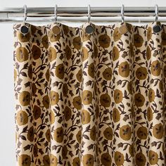 a curtain with an orange and brown flower pattern