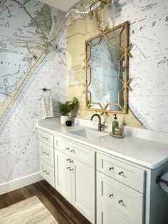 a bathroom with a large map on the wall and two sinks in front of it