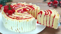 a white cake with raspberry filling on a plate next to a piece of cake