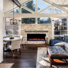 a living room filled with furniture and a fire place in the middle of a room