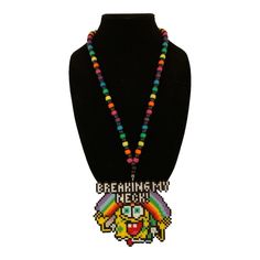 This unique Kandi necklace features a vibrant rainbow design with a yellow sponge pendant. Perfect for festivals and other special occasions, this handcrafted piece is sure to make a statement. The necklace is made from high-quality materials and is designed to be comfortable to wear for extended periods of time. Ideal for those who love artisan jewelry, this necklace is a must-have addition to any collection. The pendant is carefully crafted to ensure that it will hang beautifully from the necklace chain. Whether you are dressing up for a special event or just want to add some color to your everyday outfit, this necklace is sure to impress. Kandi Necklace, Diy Kandi, Melty Bead Patterns, Kandi Ideas, Perler Ideas, Diy Perler Bead Crafts, Festival Gear, Kandi Patterns, Kandi Bracelets