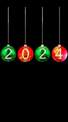 christmas balls hanging from strings with the numbers 2012 written on them in green and red