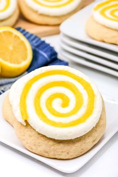 a close up of a cookie on a plate with some lemons in the background