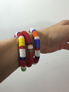 "Here is a set of three (3) gorgeous bangle bracelets from the Maasai tribe in Kenya. Black seed beads are accented with gold geometric pattern and colorful stripes. Bracelets measures approx. 2-1/2\" inside diameter. A wonderful gift to give to that someone special or to keep for yourself! NOTES: ~I make every attempt to list and picture any flaws within all of my item descriptions, such as any prominent chips, cracks, stains, discoloration or missing elements. Please refer to pictures, as they African Beaded Bracelets, Gold Geometric Pattern, Hand Beaded Necklace, Beaded Bangles Bracelets, Native American Necklace, Glass Bead Bracelet, Bead Bangles, Black Seed, Maasai