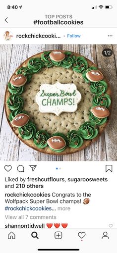 a cookie decorated like a football and the words super bowl champs on top of it