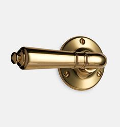 an antique brass door handle on a white background