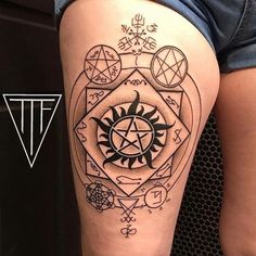 a woman's thigh with tattoos on it and an image of a pentagramil