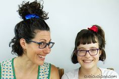 two women sitting next to each other smiling