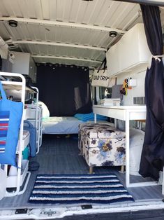 the interior of an rv with blue and white decor on it's bed area