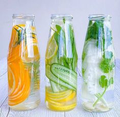 three glass vases filled with different types of vegetables