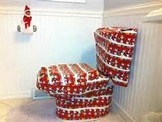 the toilet is covered with christmas wrapping