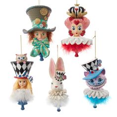 four ornaments are hanging from strings in the shape of animals wearing hats and dress up clothes