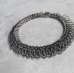 Hello! I made this Choker Necklace using strong & skin-friendly, Stainless Steel rings, with the ancient craft of chainmail. * This handmade jewelry will look cool & unique on your neck. (Be ready for curious questions ;) * It would be a perfect gift for a loved one, friend or a stylish family member 🎁 - The technique used here is Vipera Scale chainmail pattern where all the rings were attached to each other one by one by hand. - It is a limited number production and a unique design.  HOW TO TAKE CARE OF YOUR ACCESSORY? Stainless steel is great for jewelry because it's so durable, but you still need to care for it in order to keep it looking good and lasting longer. * Clean regularly with mild soap and warm water. * Rinse thoroughly to remove any soap residue. * Dry with a soft, lint-free Scale Chainmail, Chainmail Choker, Chainmail Patterns, Chainmail Necklace, Chainmail Jewelry, Pendant Tutorial, One Friend, Scale Pattern, Chain Maille