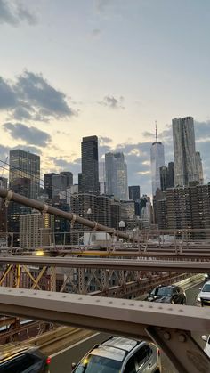 cars are driving over a bridge in the city