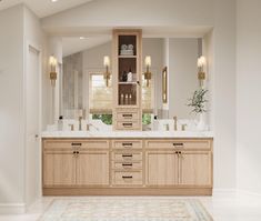 a large bathroom with double sinks and wooden cabinets in it's centerpieces