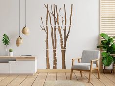 a living room with white walls and wooden flooring is furnished with a modern chair