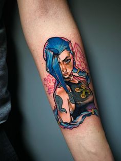 a woman with blue hair and tattoos on her arm is shown in this tattoo photo