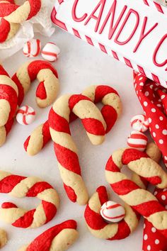 red and white candy cane cookies are on the table