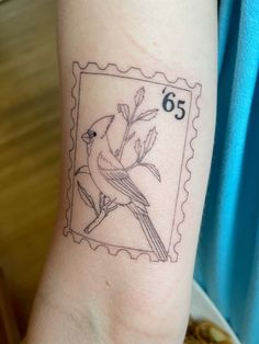 a stamp with a bird on it and the number six is in front of someone's arm