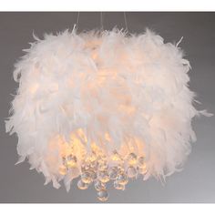 a chandelier with white feathers hanging from it's center and crystal beads on the bottom