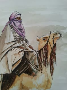 a man riding on the back of a camel