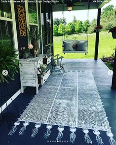 a porch with a rug on the floor