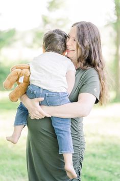 a woman holding a baby in her arms