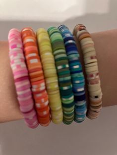 These are clay beaded bracelets! They can be pink, orange, yellow, green, blue, or brown! Orange Clay Bead Bracelets, Clay Beaded Bracelets, Clay Bead Bracelets, Christmas Fair Ideas, Roses Orange, Pink Orange Yellow, Clay Bead, Bead Bracelets, Clay Beads