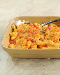 a casserole dish is shown with a spoon in it