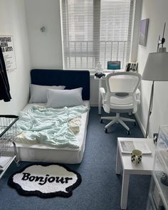 a small bedroom with a bed, desk and computer chair in it's corner